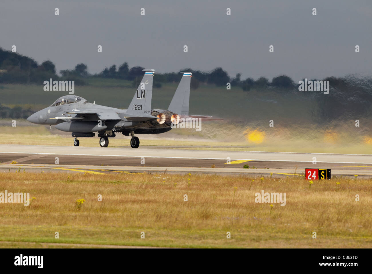 USAF McDonnall Douglas F-15E Strike Eagle going down runway with afterburners on Stock Photo