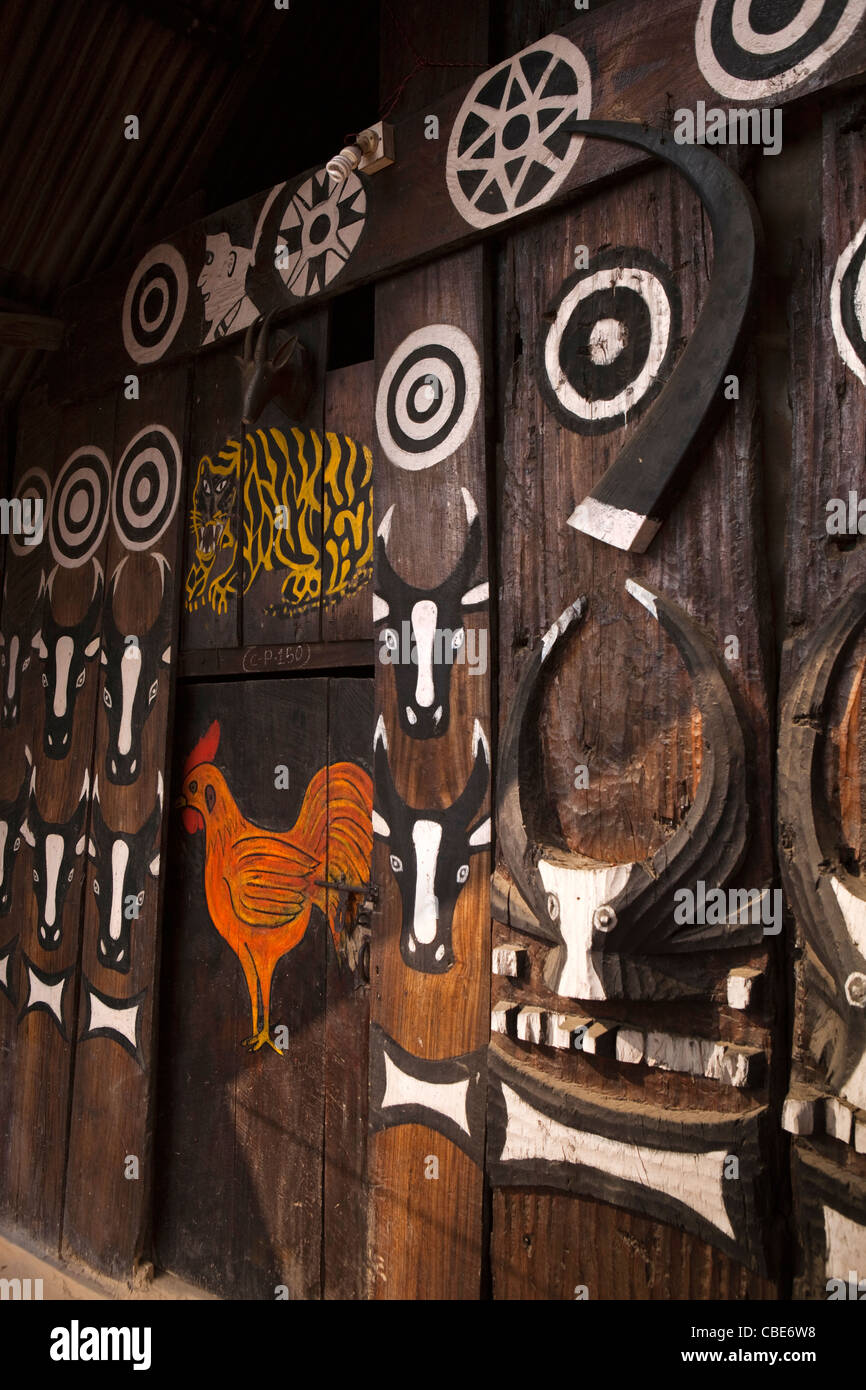 India, Nagaland, T Khel, Old Kohima Village, traditionally decorated carved house front panels with buffalo motif Stock Photo