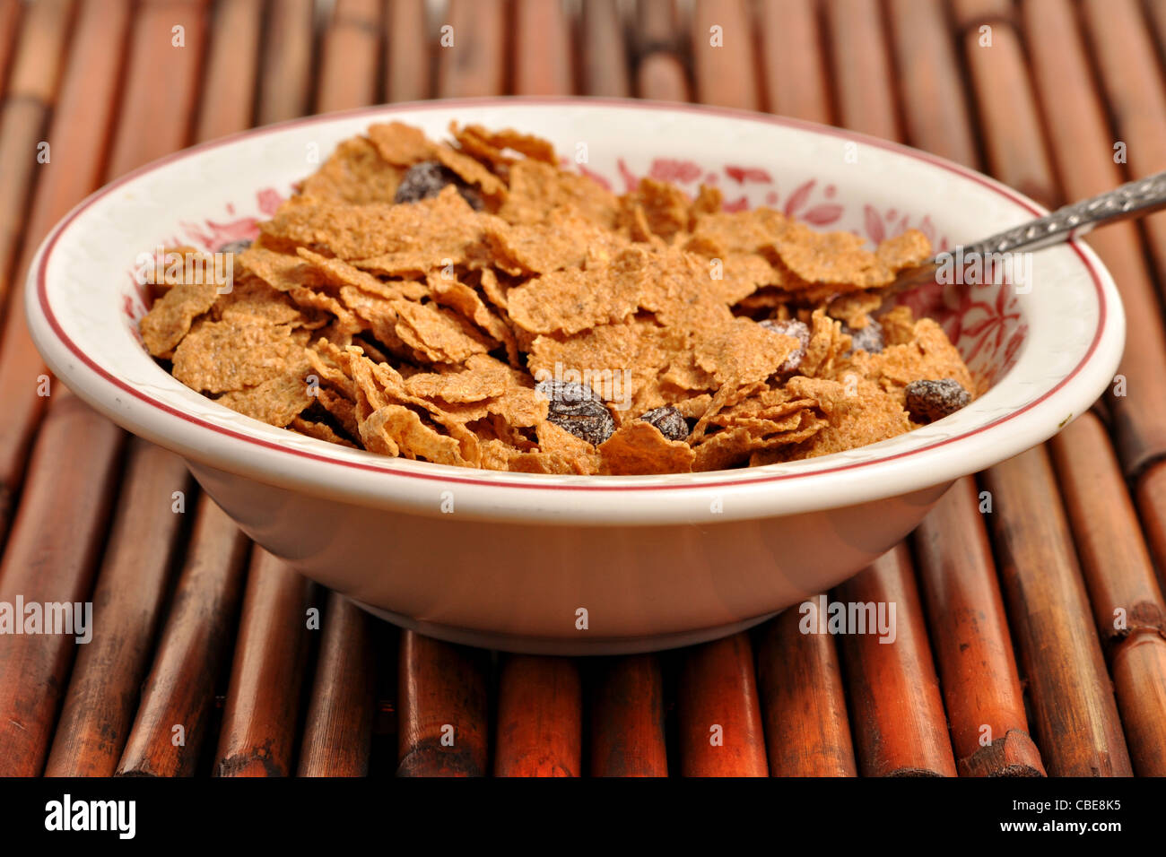 A bowel of bran flakes is mixed with raisins Stock Photo Alamy