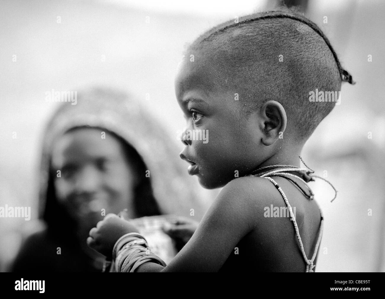 Baby with shaved head and necklace Stock Photo