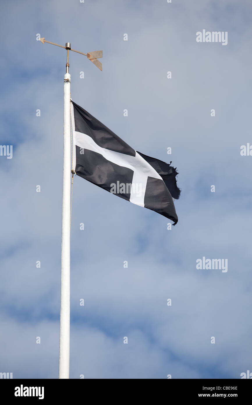 Cornish Flag flying against a blue and white sky Stock Photo