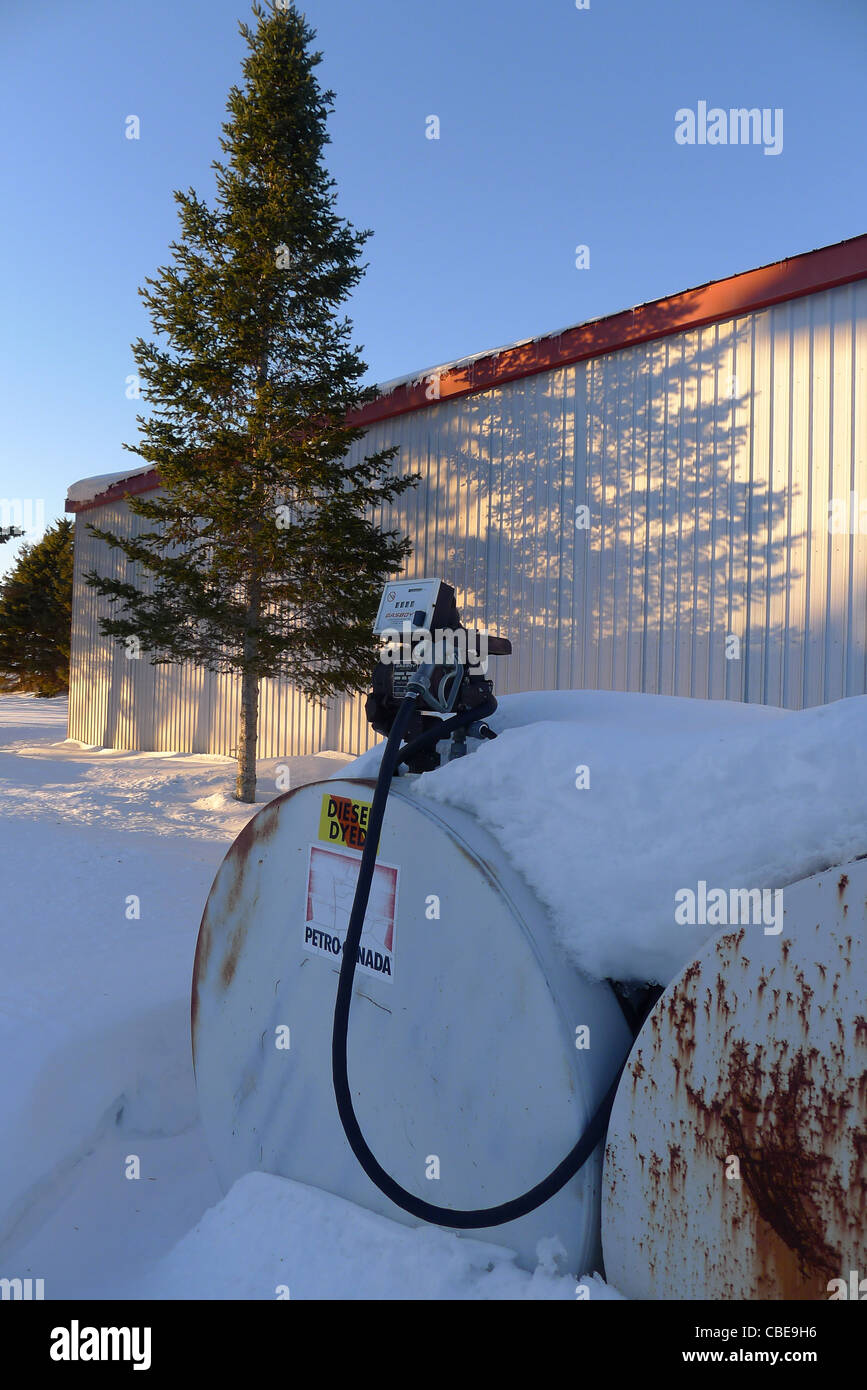 A snow covered diesel pumping station on a farm in rural Canada Stock Photo