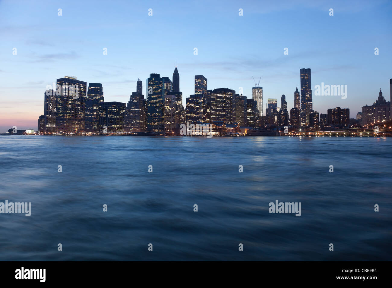 The New York City skyline at twilight w the Freedom tower Stock Photo ...