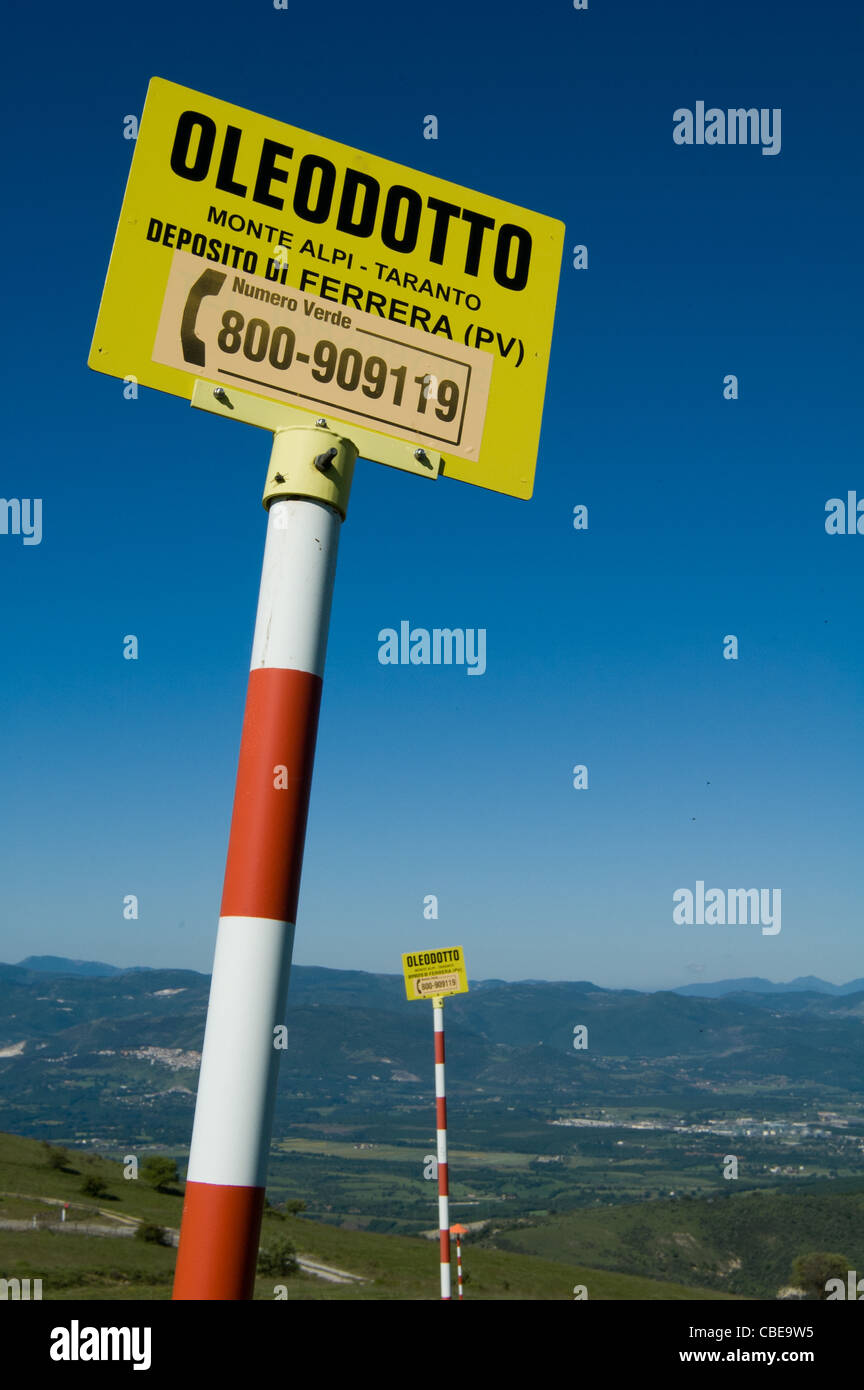 A sign indicates the presence of a pipeline underground. Viggiano