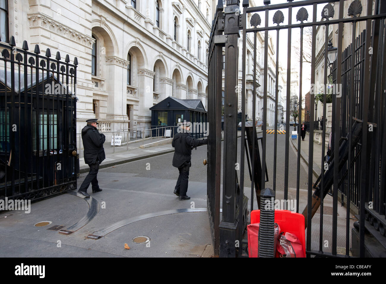 police protection officers opening security gates outside downing street on whitehall london england united kingdom uk Stock Photo