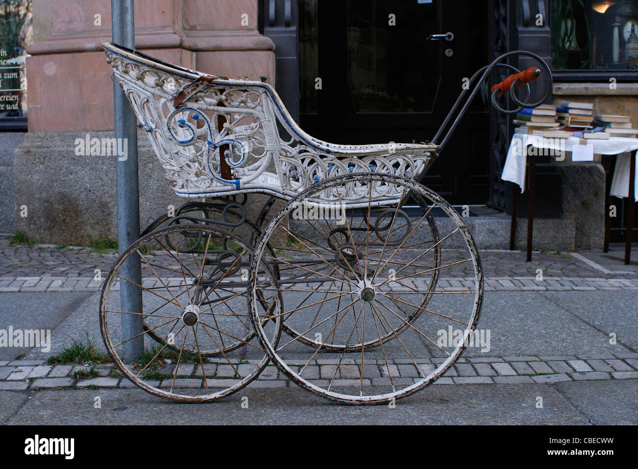 An old pram on the road in the city center of Leipzig, Germany. Stock Photo