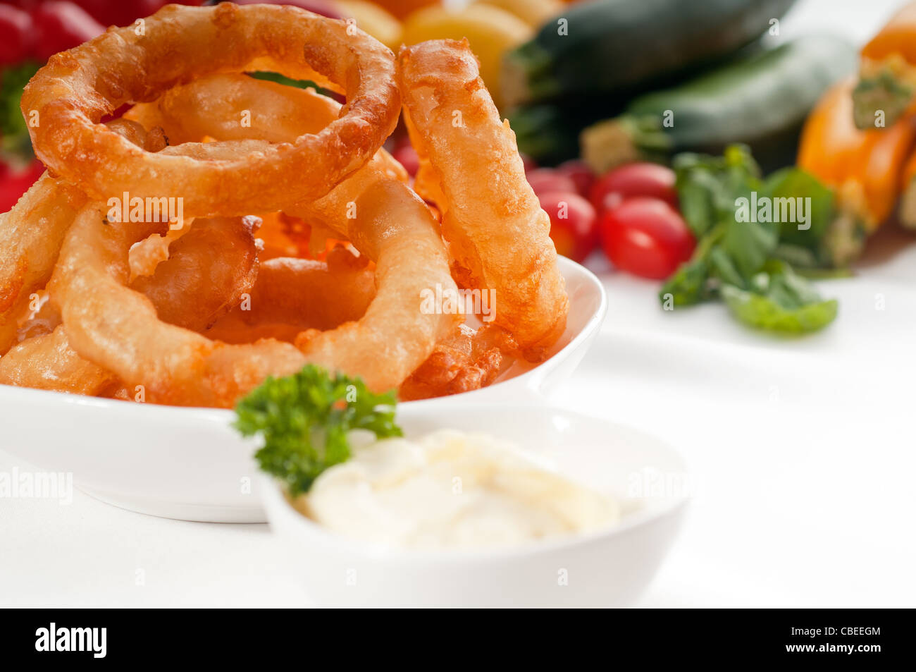 golden deep fried onion rings served with mayonnaise dip and fresh