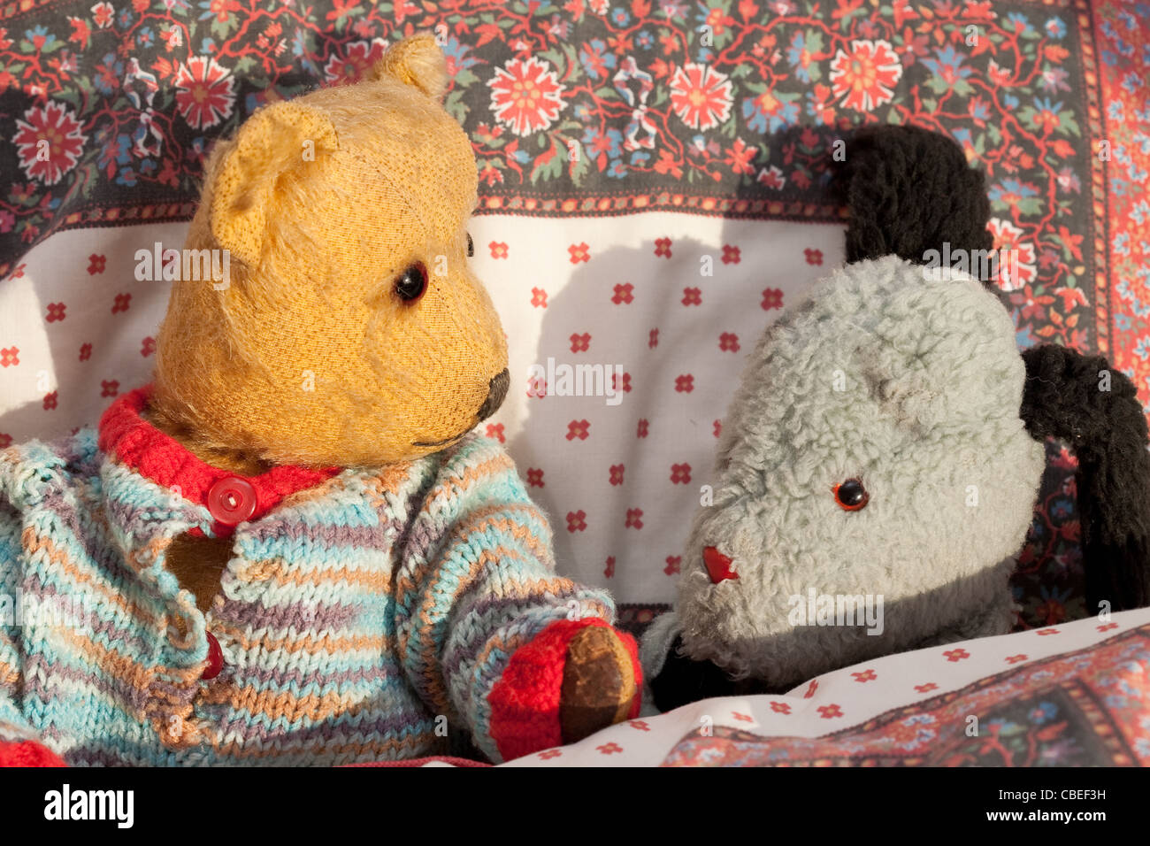 old teddybear and puppet (Sweep) in bed Stock Photo