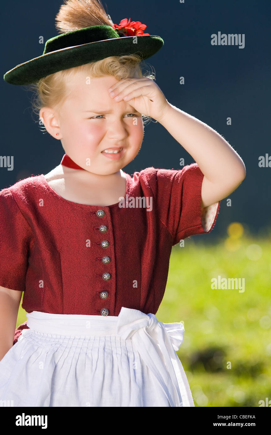 Little girl in a dress looks in the country Stock Photo Alamy