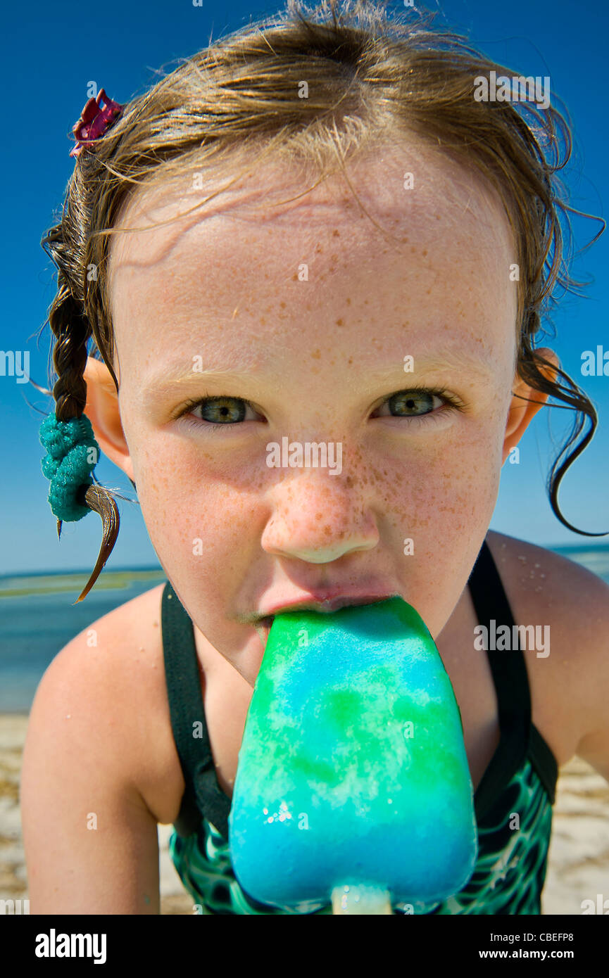 Girl eating a popsicle at the beach Stock Photo Alamy