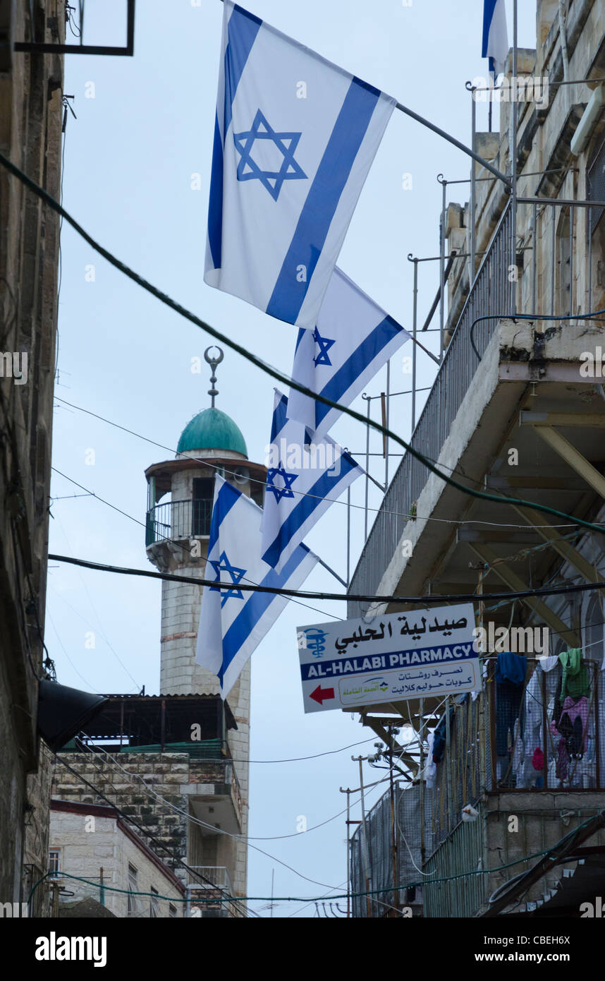 Israeli flags and minaret in the Muslim Quarter. Jerusalem Old City. Israel Stock Photo