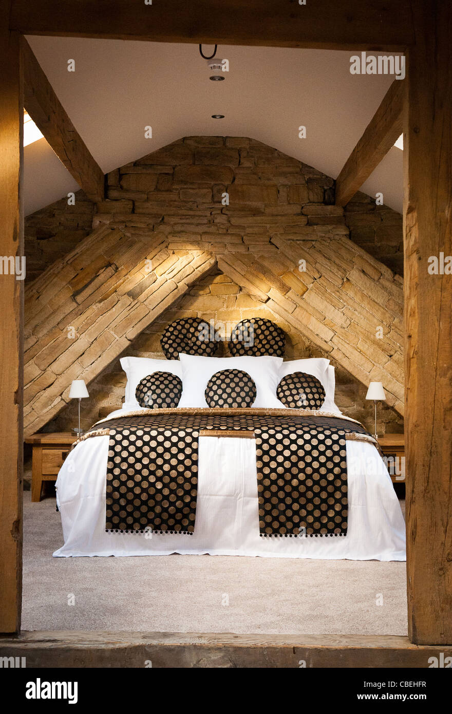 Here's an opulent bedroom in a swanky hotel in the UK built into what used to be the attic. Stock Photo