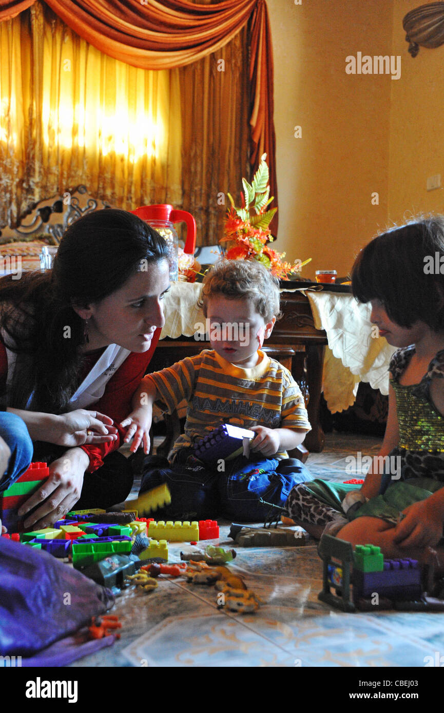 Palestinian families traumatized by the coming of the Israeli colonists., The psychologist tries to make Gina speak, after mute Stock Photo