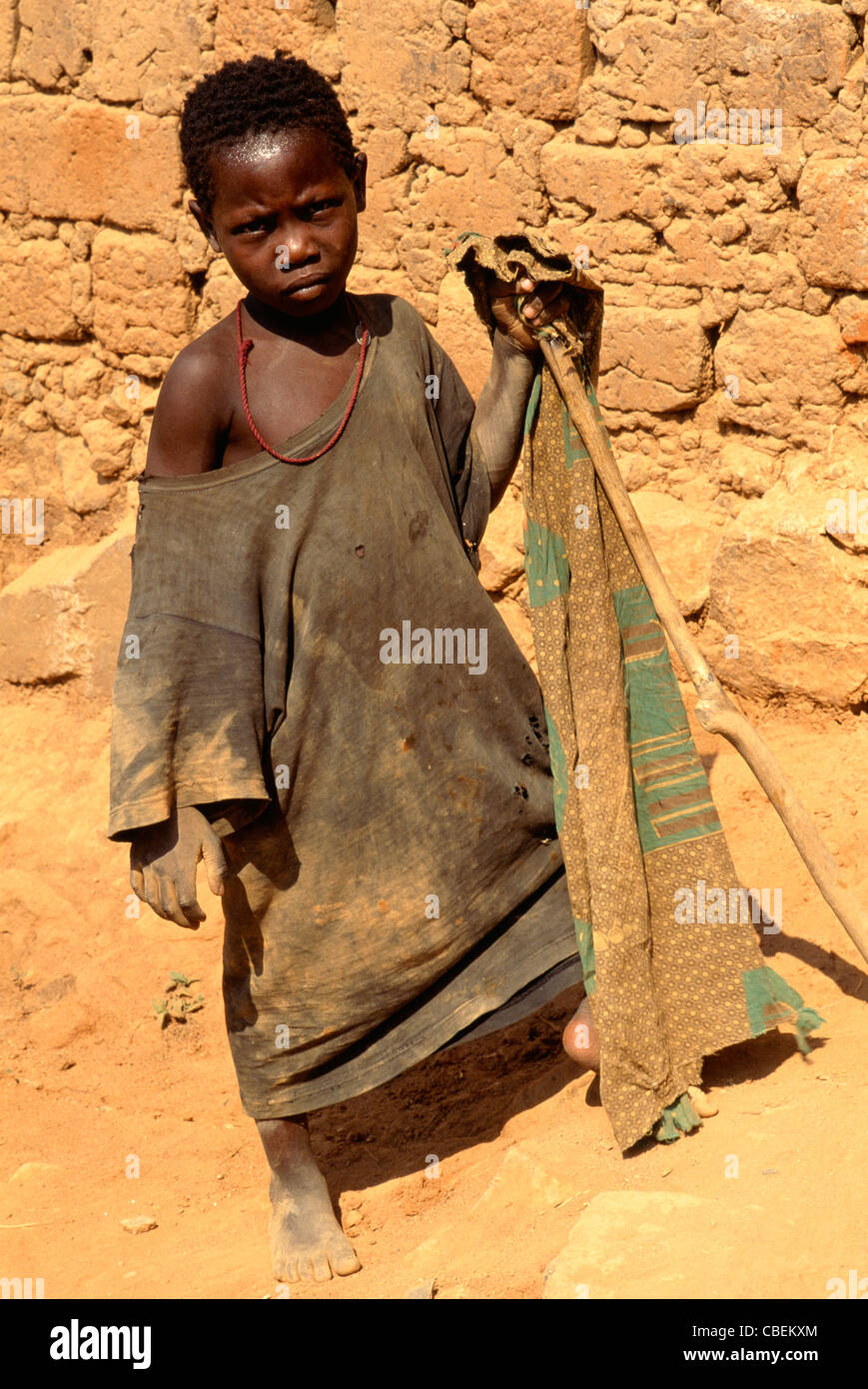 Kala, Tanzania. Girl in ragged clothes holding a stick; Lake Tanganyika  Stock Photo - Alamy