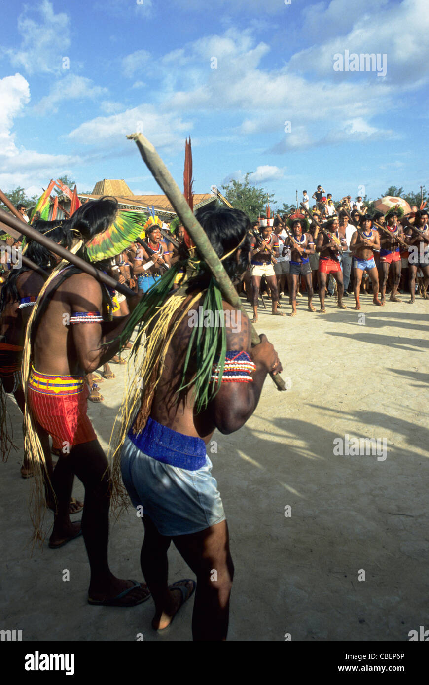 Altamira, Brazil. Kayapo Indians in a war dance with borduna clubs wearing feather headdresses. Stock Photo