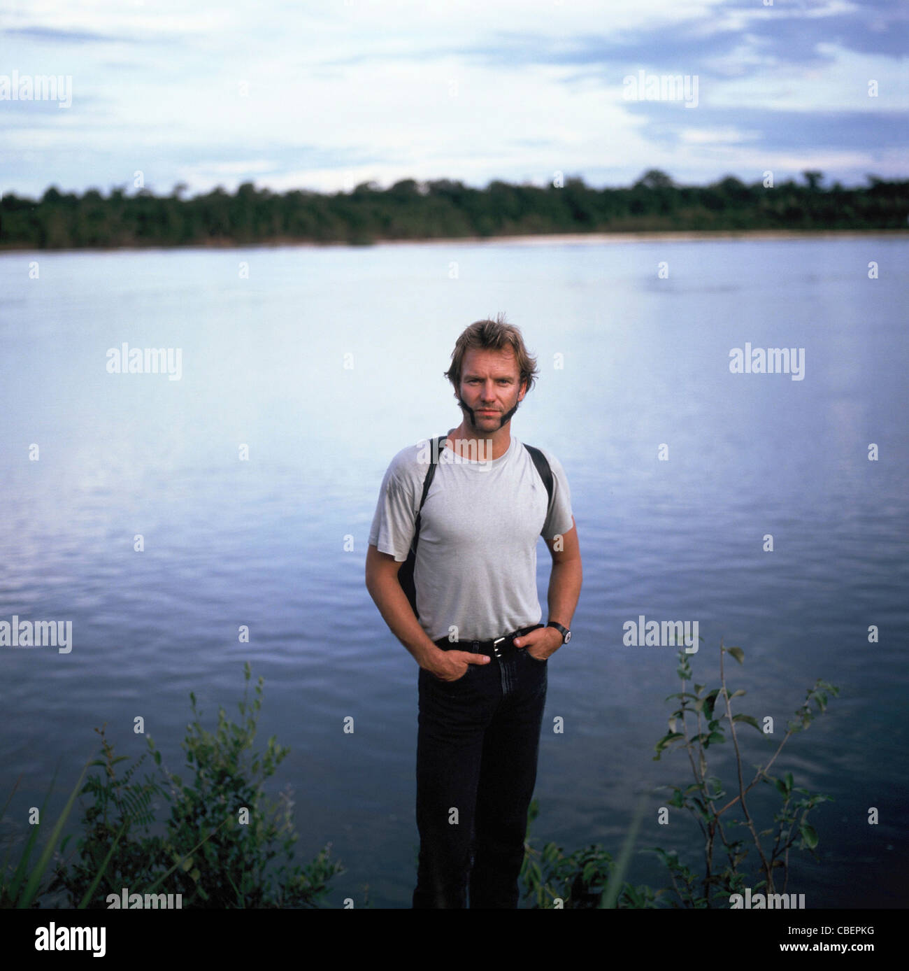 Xingu River, Brazil. Sting with intricate face paint standing on the shores of the Xingu River. Stock Photo
