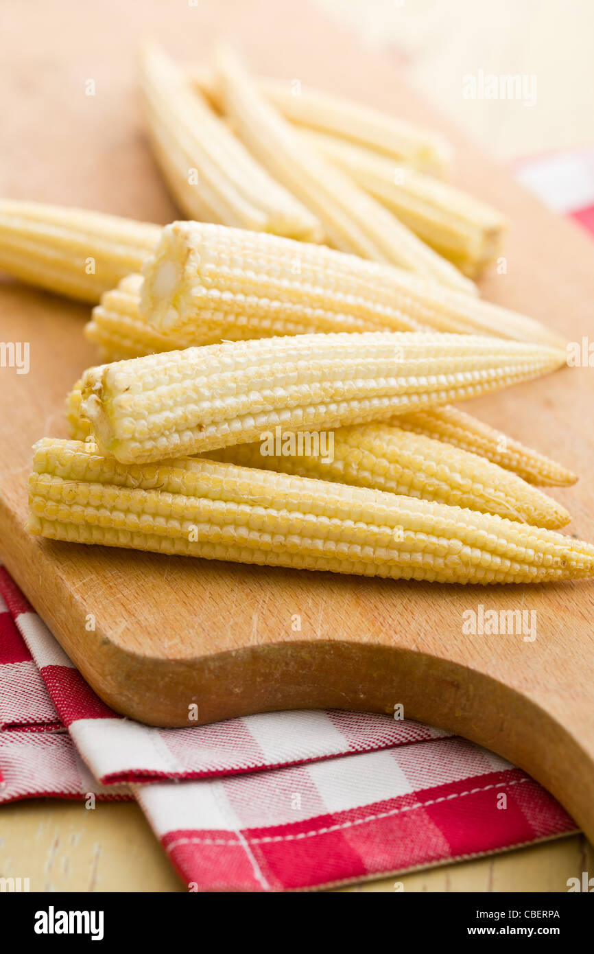 Baby corn cobs on kitchen table Stock Photo