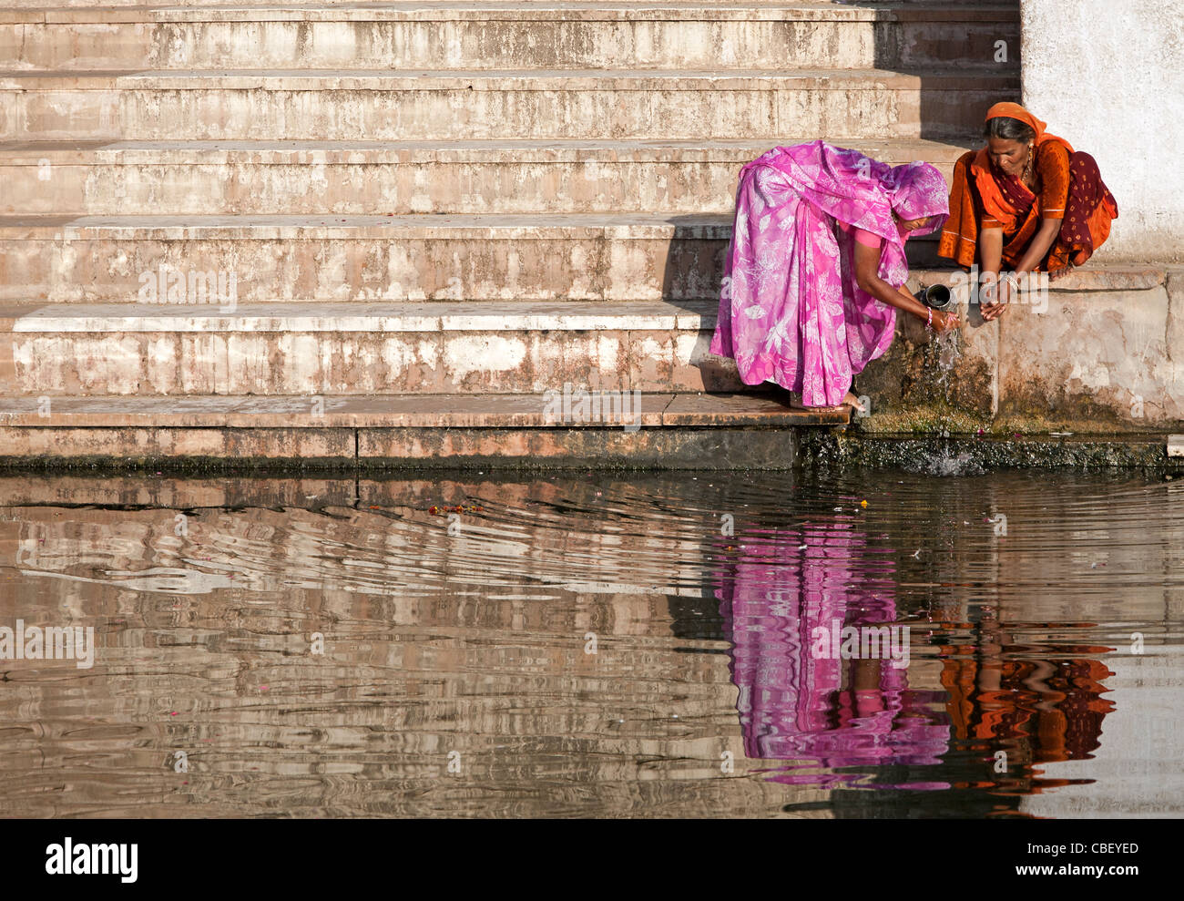 Indian women washing their hands. Pushkar sacred lake. Rajasthan. India Stock Photo