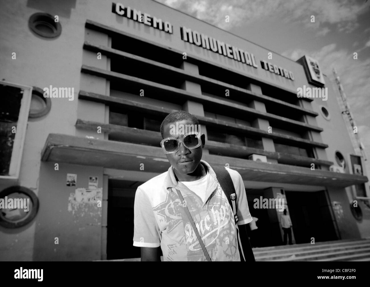 Young Fashionable Man In Front Of Benguela Art Deco Cinema Theater, Angola Stock Photo