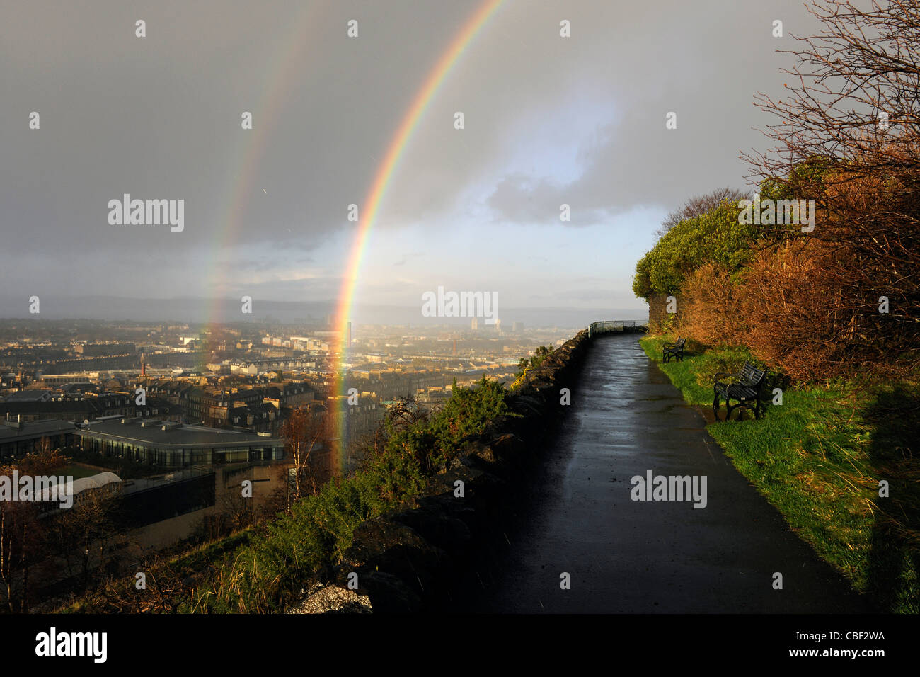 View of streaking rain and double rainbow and New Town and Firth of Forth from Calton Hill. Edinburgh, Scotland. Stock Photo