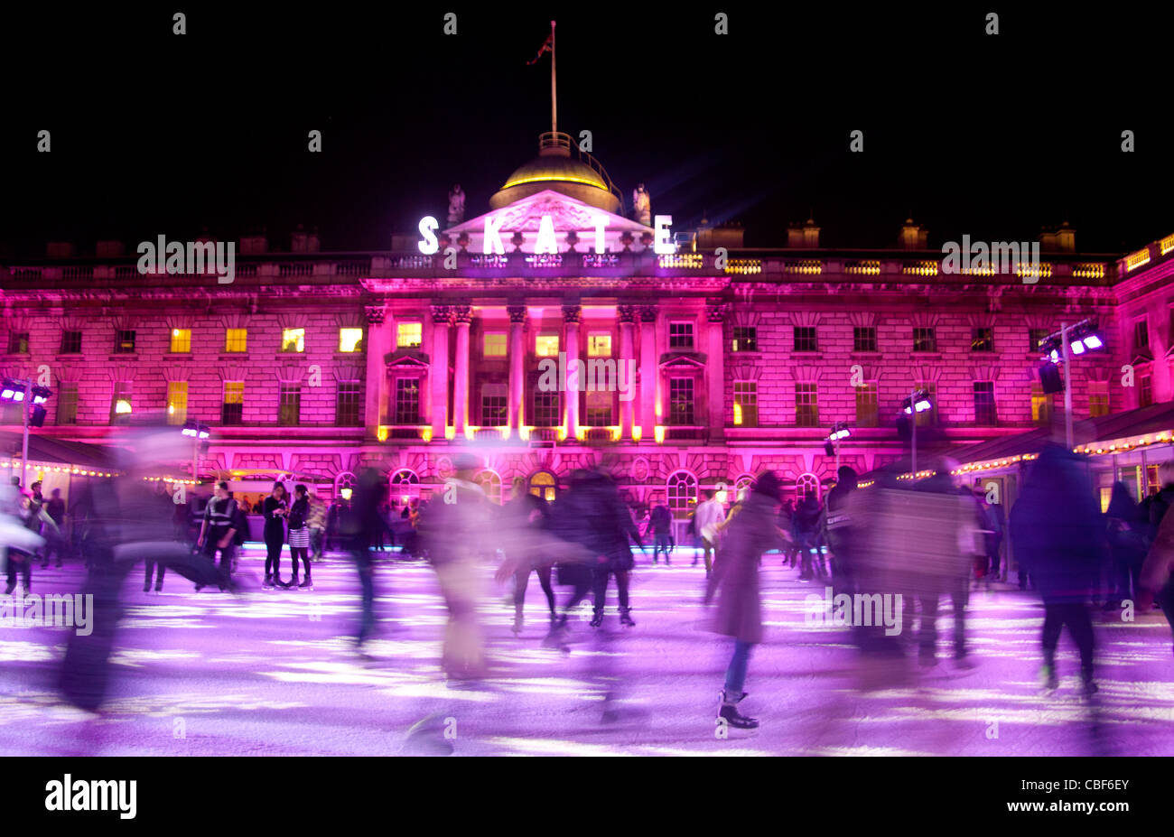 Somerset House Christmas ice rink with people skating at night December 2011 The Strand London England UK Stock Photo