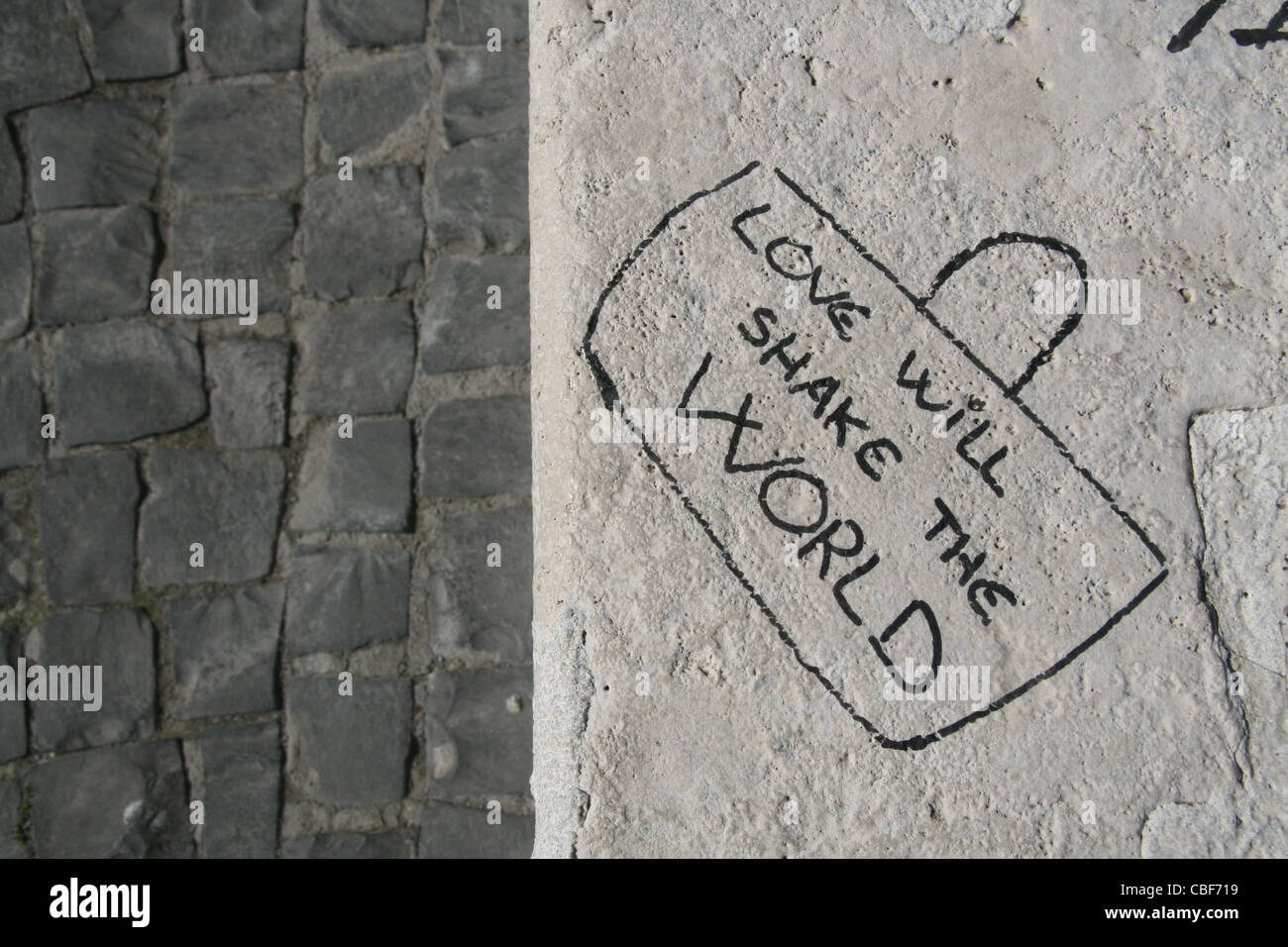 love will shake the world sentence graffiti written on wall Stock Photo