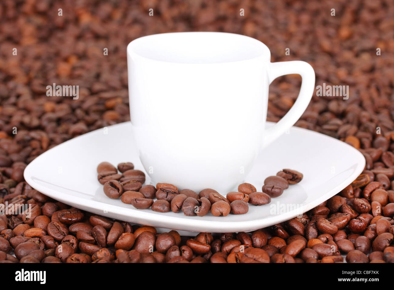 White cup in coffee beans, closeup Stock Photo