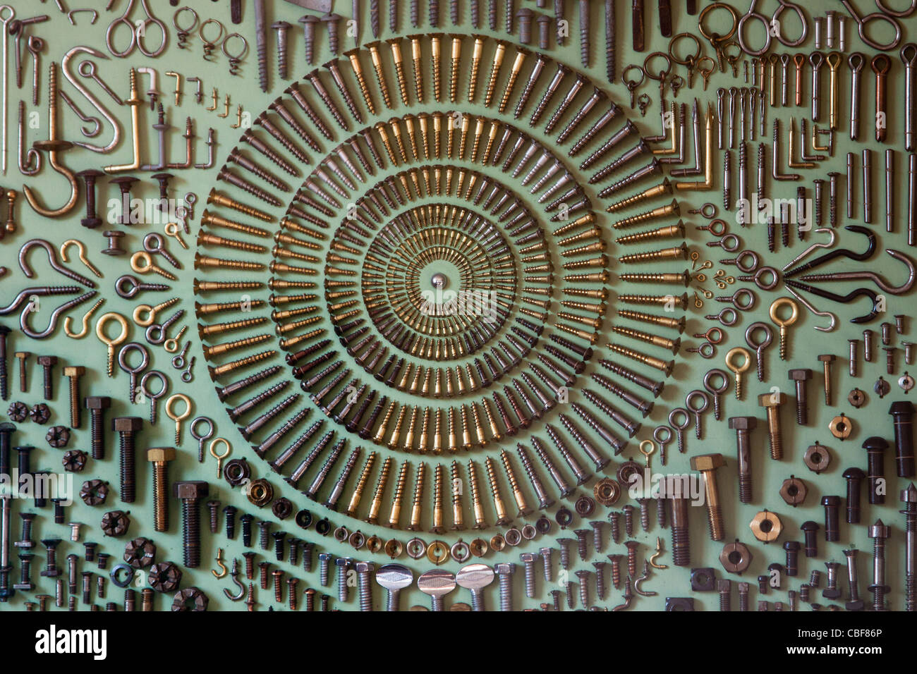 screws hooks eyes rivets nuts and bolts mounted in regular pattern on ...