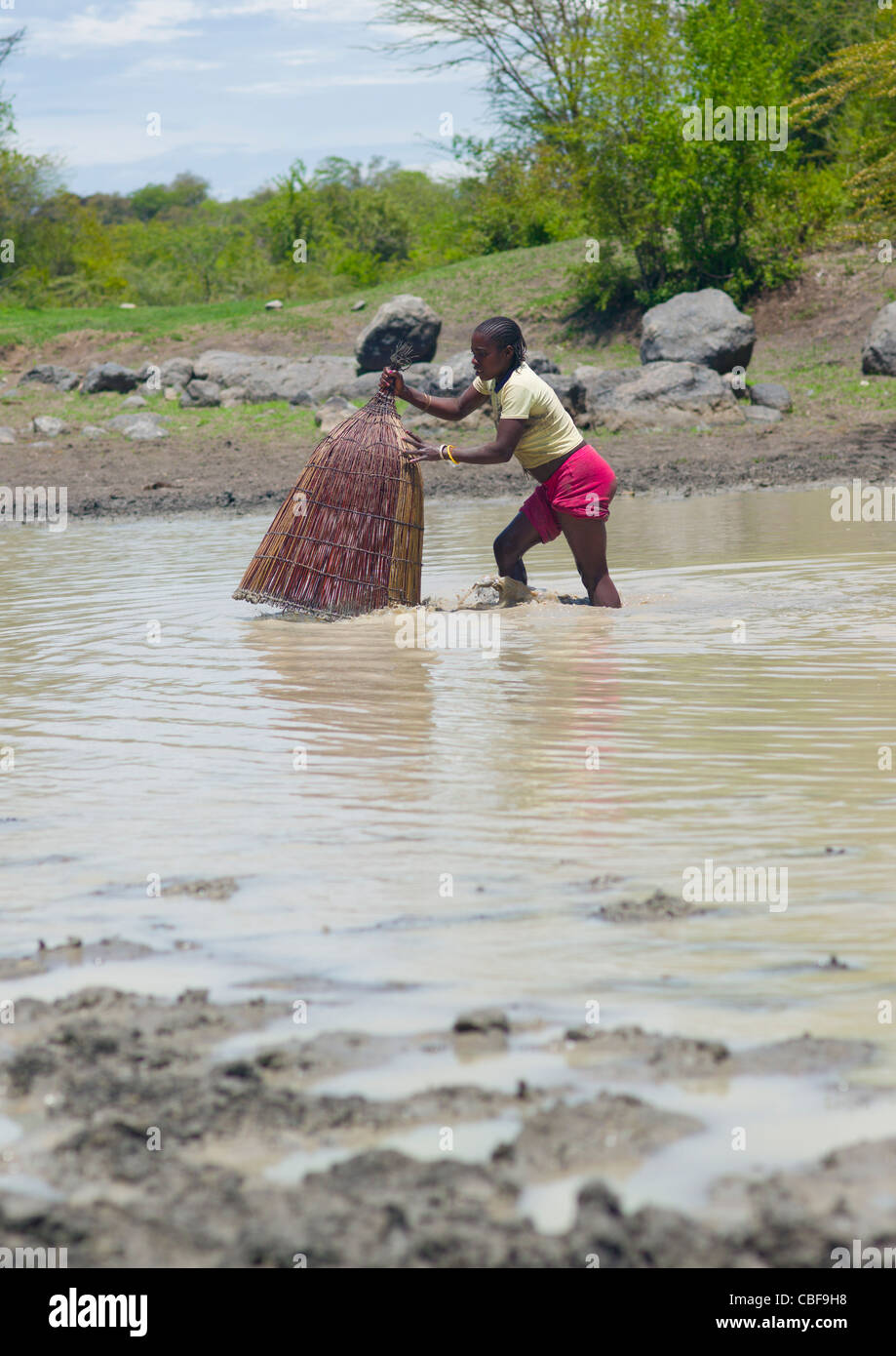 Girl Fishing In The River With A Basket Net, Angola Stock Photo - Alamy