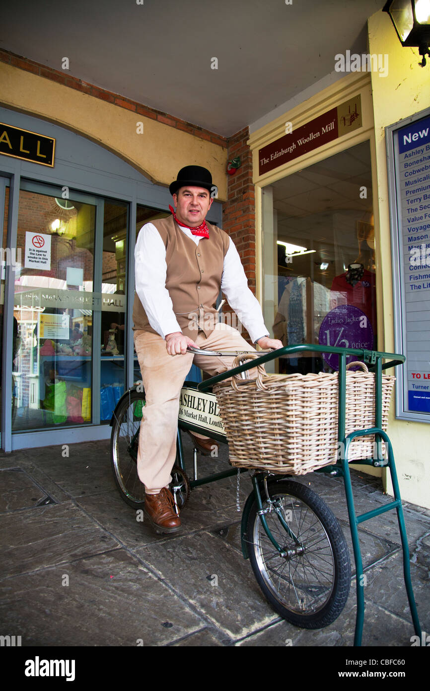 Louth Victorian Market, Lincolnshire, England man with bowler hat on  traditional butcher bike with basket from victorian era Stock Photo - Alamy