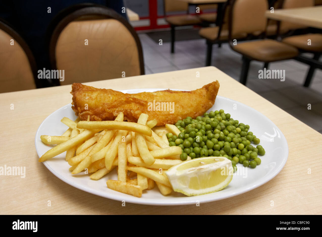 battered fish chips and peas in a cafe in london england united kingdom