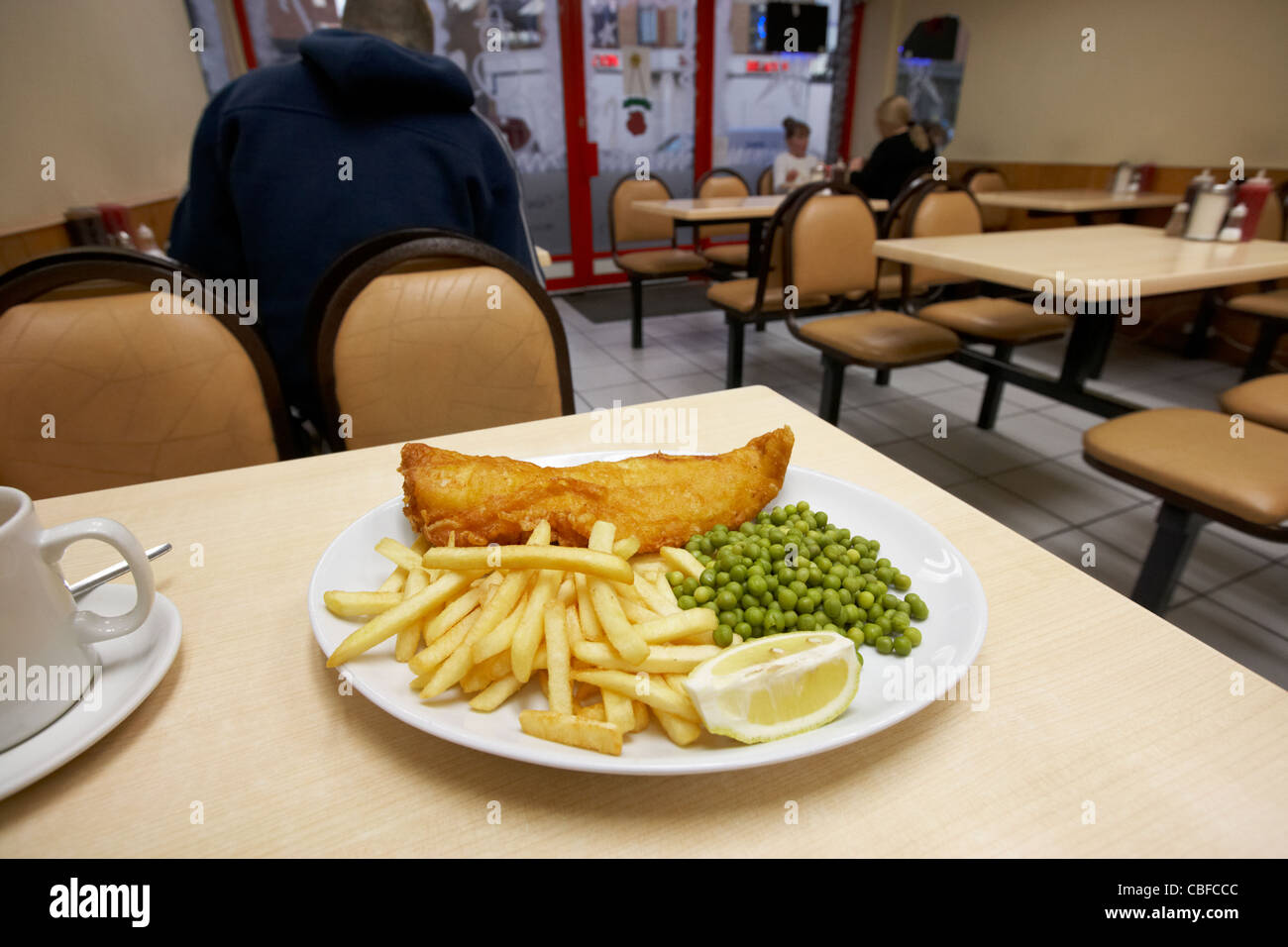 battered fish chips and peas in a cafe in london england united kingdom