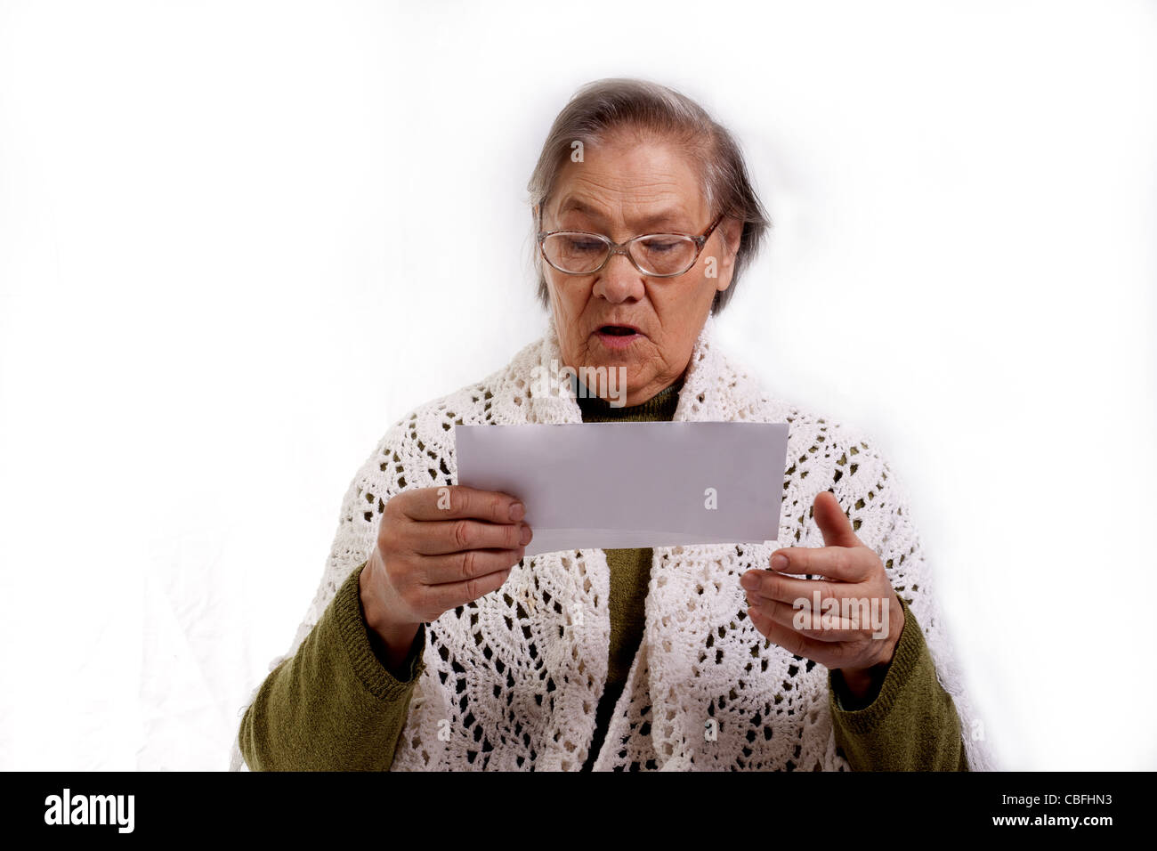 old woman shocked about her bills isolated on white background Stock Photo