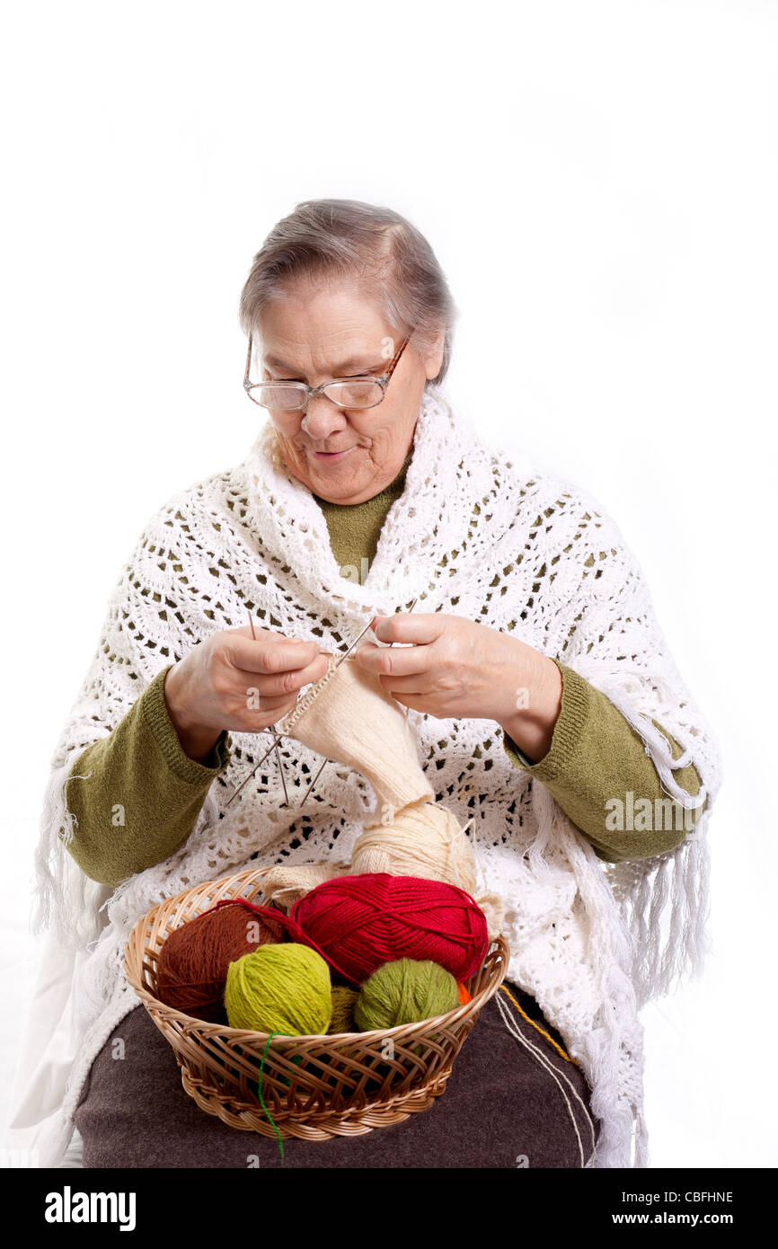 Senior woman knitting isolated on white background Stock Photo - Alamy