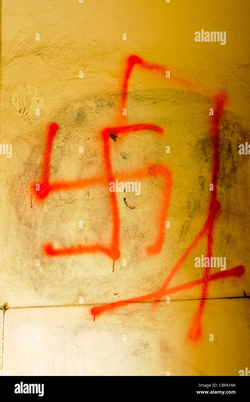 Graffiti on wall in Krakow of a Swastica hanging from hangmans gallows Stock Photo