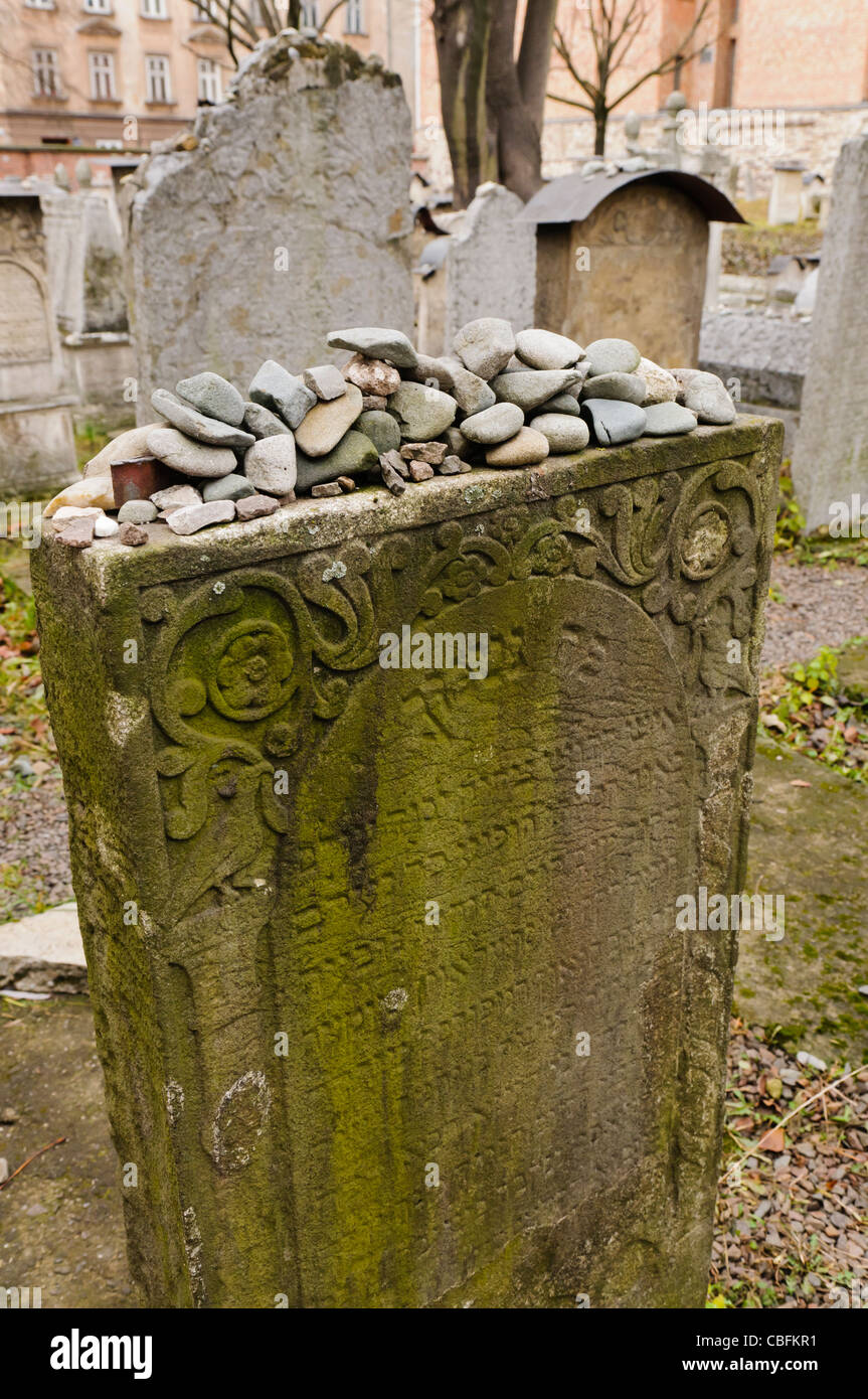 Stones piled up on a gravestone in remembrance of the deceased at a