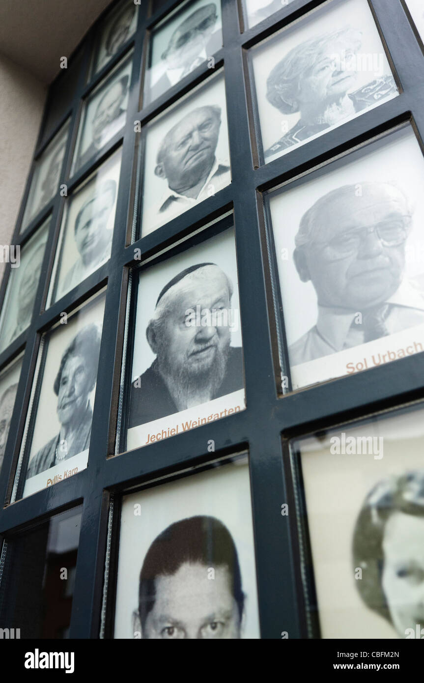 Pictures of Jewish victims of the Nazi holocaust on the windows of the Oskar Schlinder factory, Krakow Stock Photo