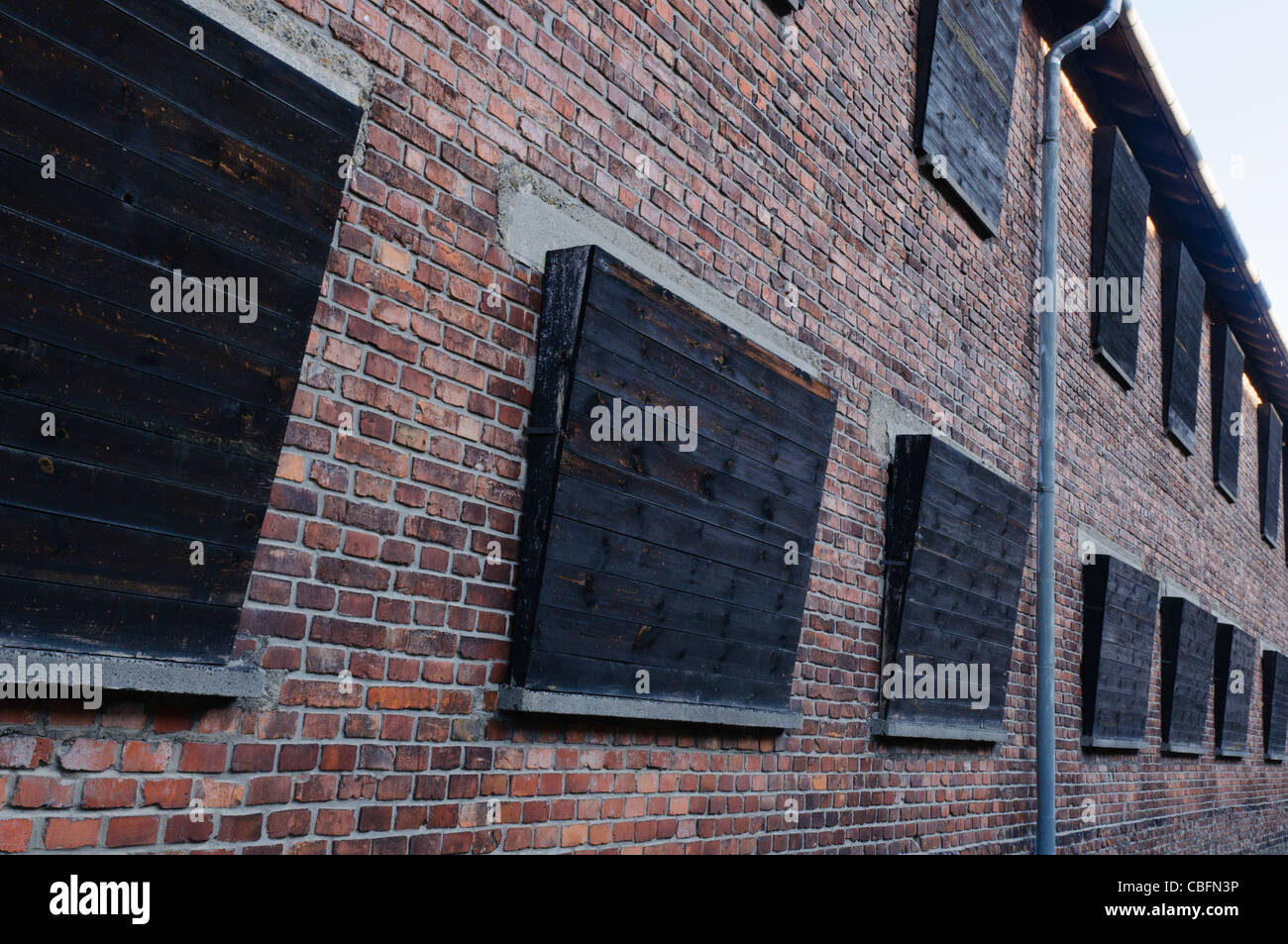 Boarded up windows of Block 10 at Auschwitz I Nazi concentration camp which overlooks the 'Execution Wall' Stock Photo