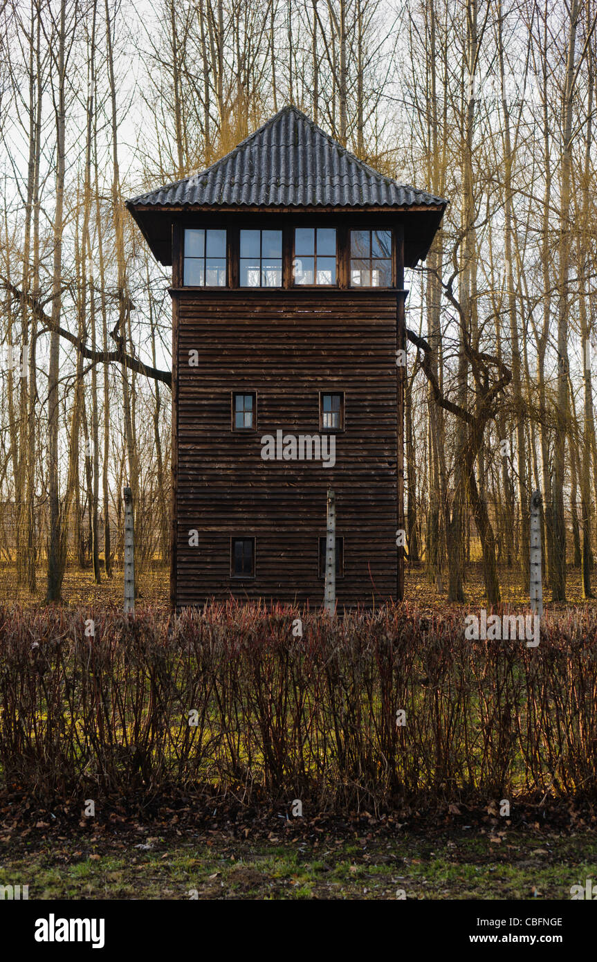 Watchtower beside electrified barbed wire security fence at Auschwitz Berkenau Nazi concentration camp Stock Photo