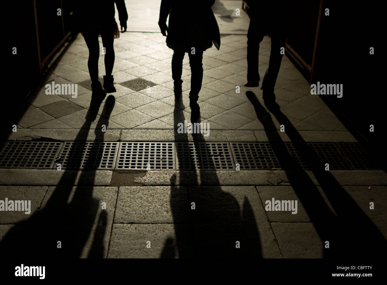 Three people silhouetted walking through a doorway in Kyoto, Japan Stock Photo