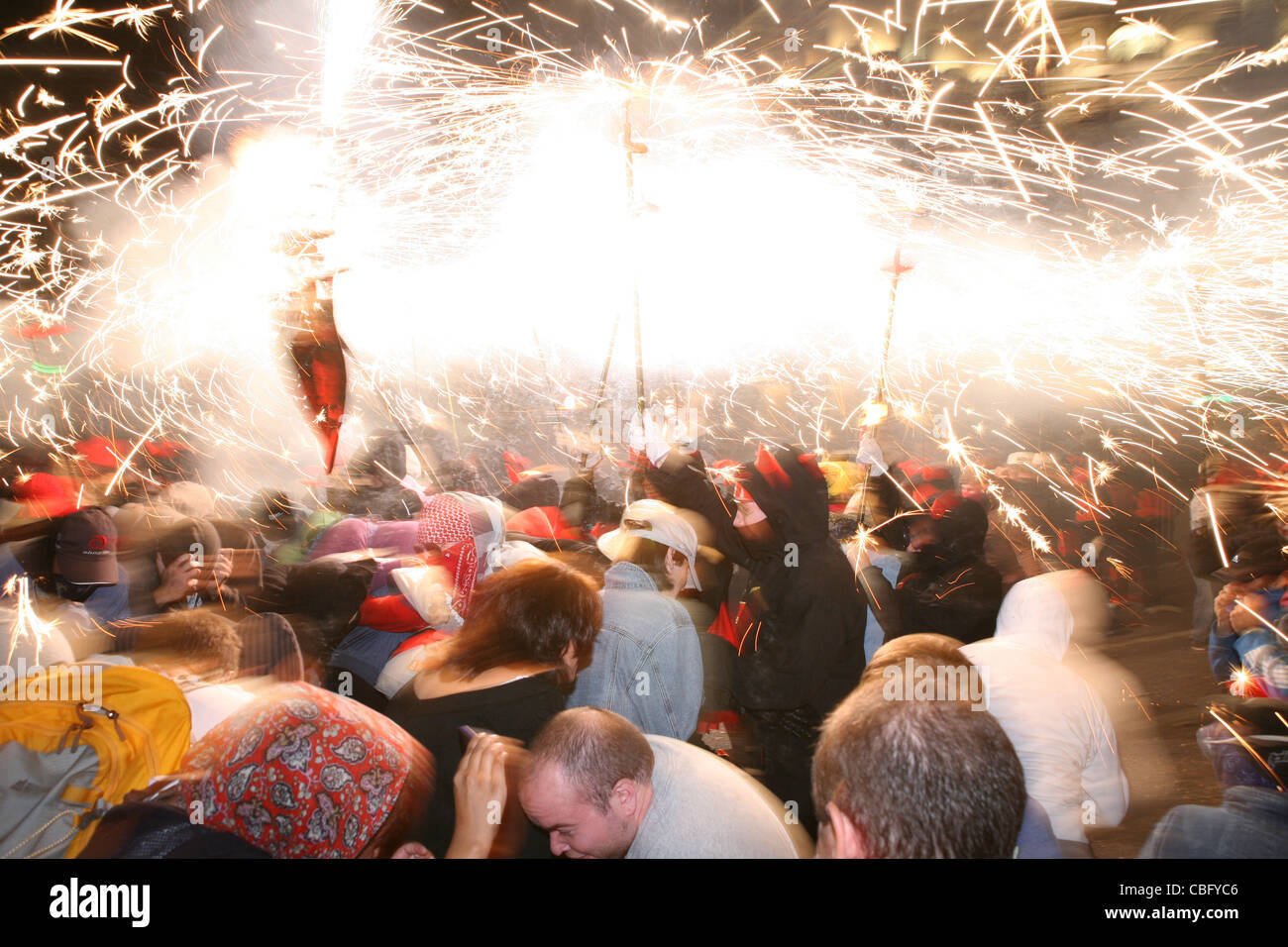 people dancing under fire in Barcelona's Mercè. Runfire and fireworks Stock Photo