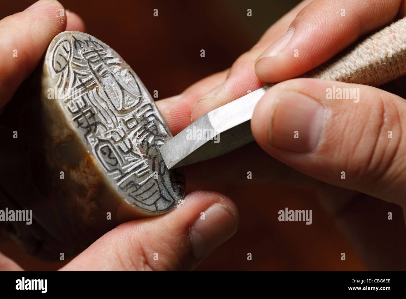 Craftsman carving Chinese character into a Chinese chop Stock Photo Alamy