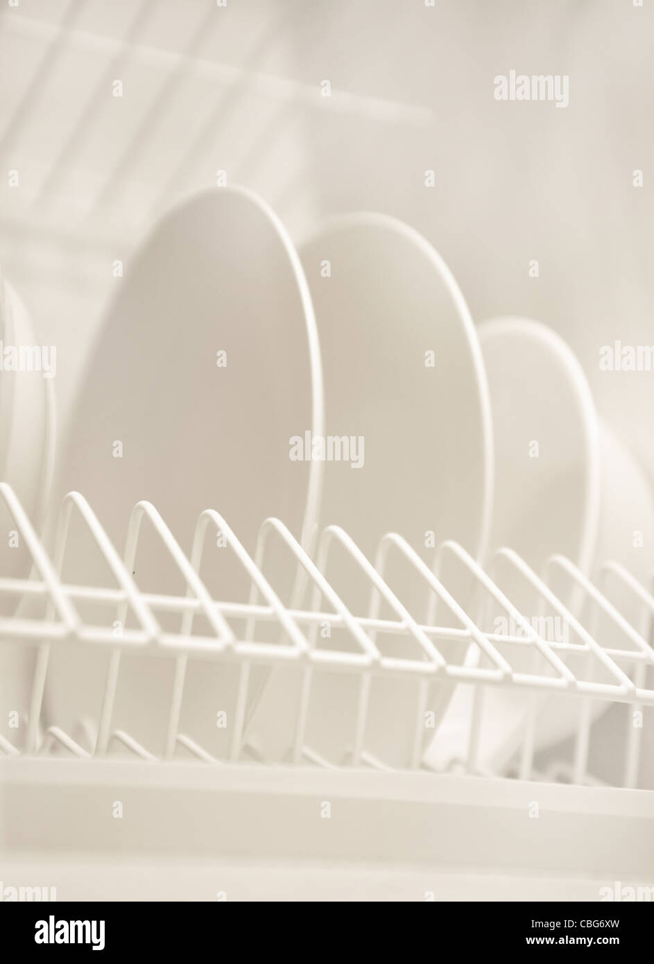 Dinner plates in a rack Stock Photo Alamy