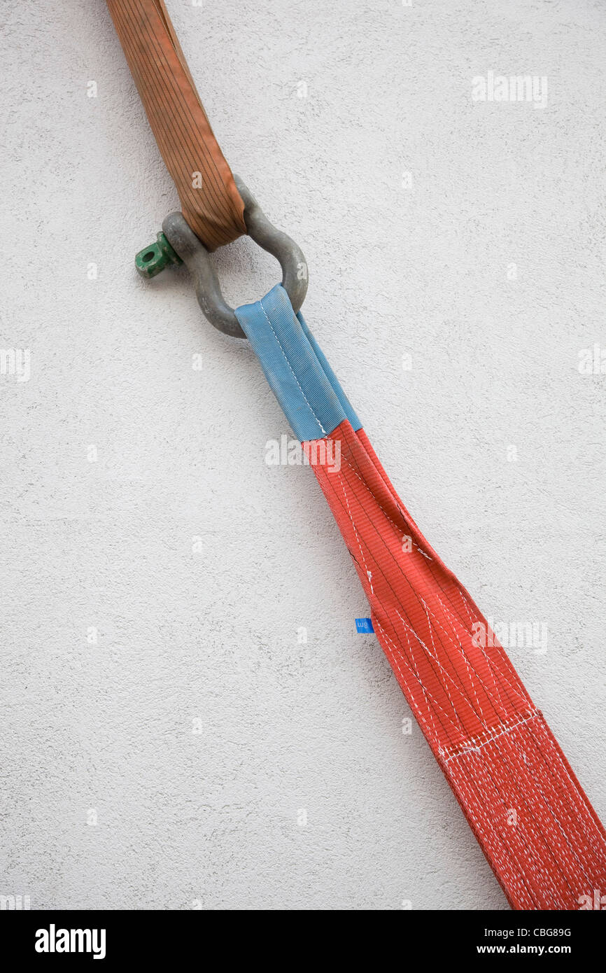 A strap with a shackle pulling another strap Stock Photo