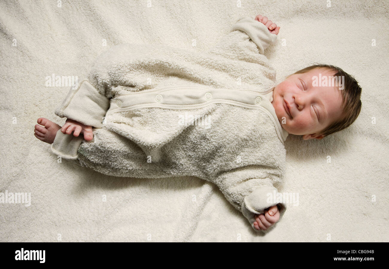 A sleeping newborn with her arms stretched out Stock Photo Alamy