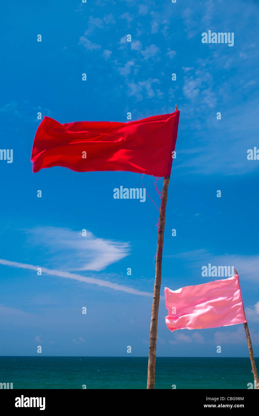 Colored flags flapping in the wind on a beach Stock Photo