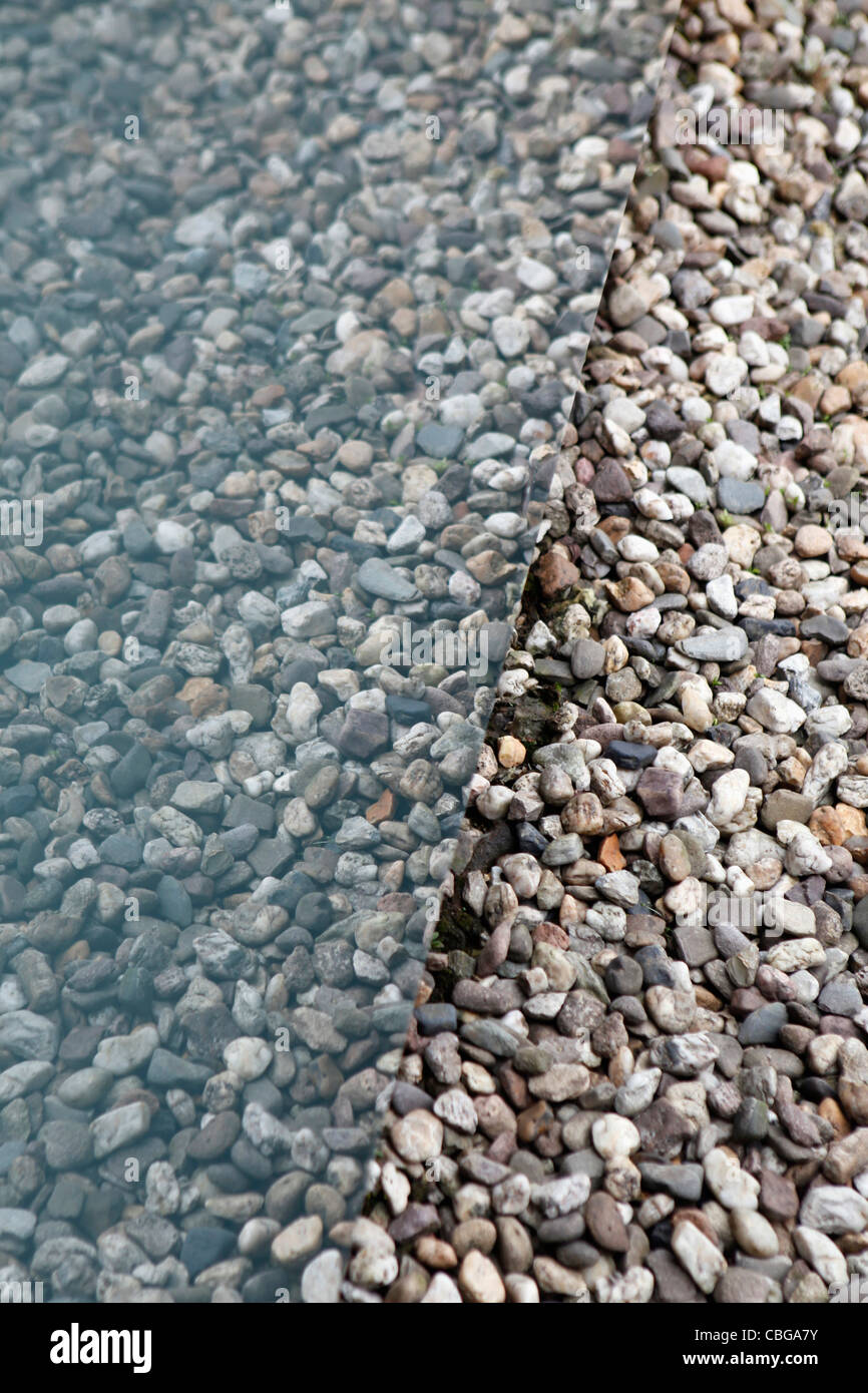 Pebbles contrasted by reflection of glass window Stock Photo