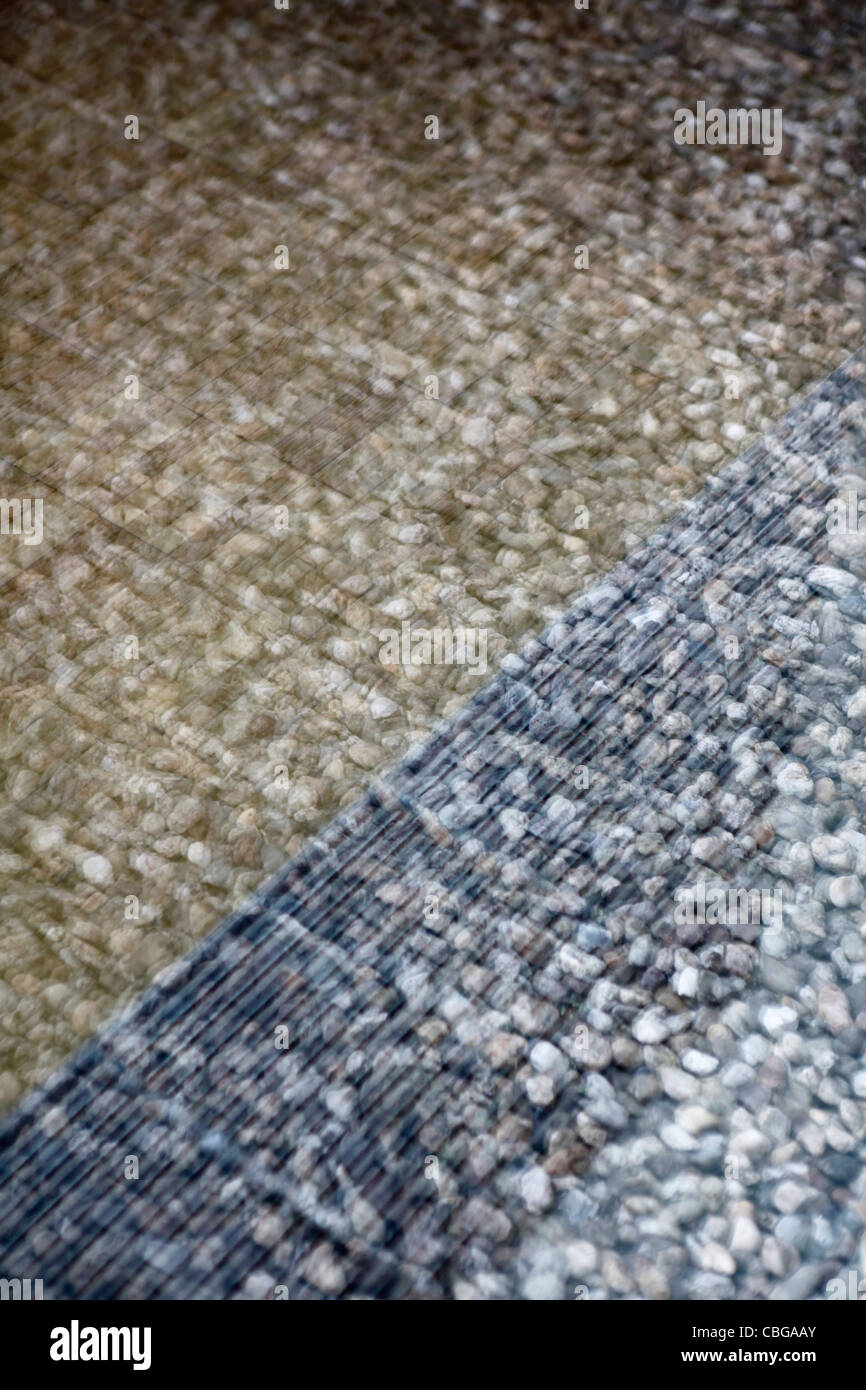 Defocused view of pebbles contrasted by reflection of window pane Stock Photo