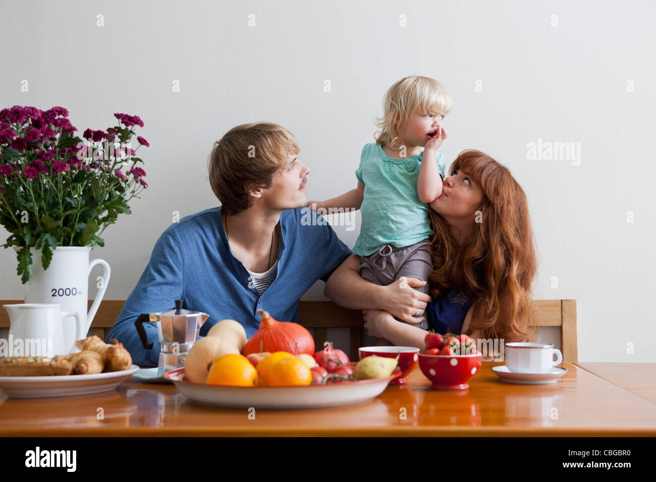 A young family having breakfast Stock Photo - Alamy