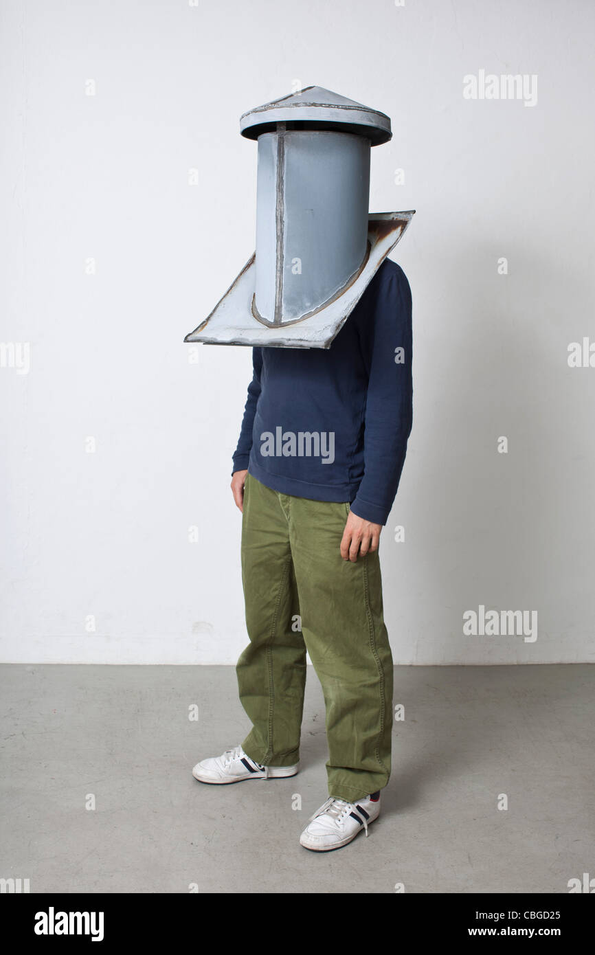Man standing with chimney cap over his head Stock Photo